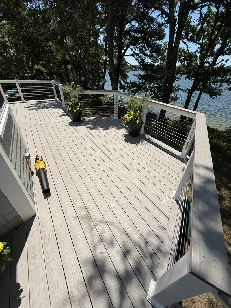 Composite deck with stainless cable railing overlooking the water